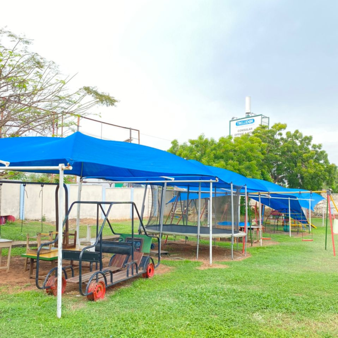 Range of specialist equipment including swings and a trampoline on a grassy field.