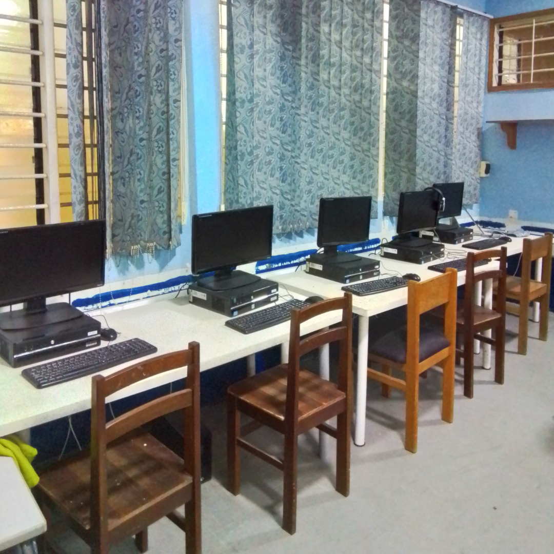 Row of computers along a desk.